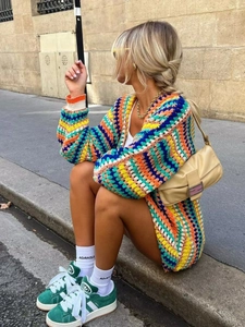 Colorful handmade crochet knit cardigan with bohemian pattern and ribbed cuffs in soft light