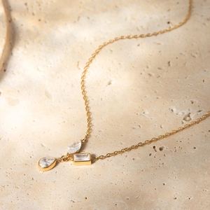 Detail of 18K gold plated necklace featuring geometric water drop and zircon pendants