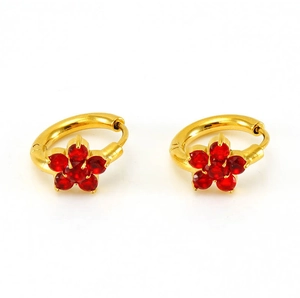 Detail of gold floral hoop earrings with sparkling red zircon stones and 5-petal charms