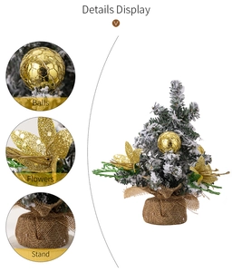 Details of tabletop Christmas tree with golden balls, flowers and burlap base