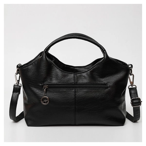 Close-up of black PU leather handbag showing texture, back zipper, and detachable strap