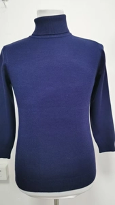 Detail of navy blue slim fit turtleneck knitwear with fine textured stitching patterns
