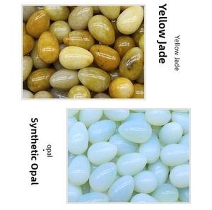 Polished yellow jade and synthetic opal stones in a smooth 30mm egg-shaped design