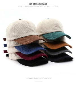 Detailed view of color-blocked corduroy baseball caps in various vintage color options
