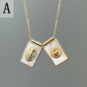 Detail of gold necklace with rectangular mother of pearl pendants and religious carvings