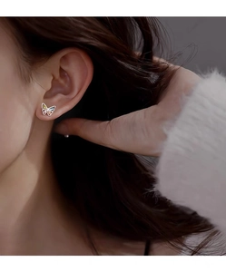 Close-up of S999 sterling silver butterfly stud earrings with colorful gemstones on ear