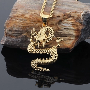 Macro detail of golden dragon pendant with textured scales on rugged rock background