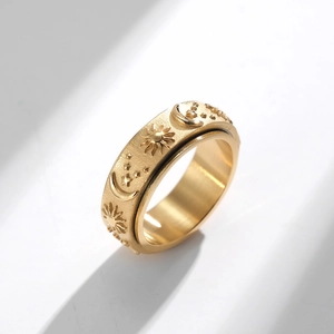 Golden stainless steel spinner ring featuring engraved sun moon and star celestial patterns