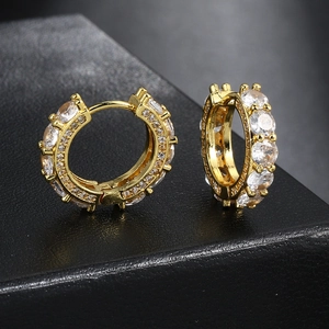 Iced out gold hoop earrings with micro-paved zircons on black background