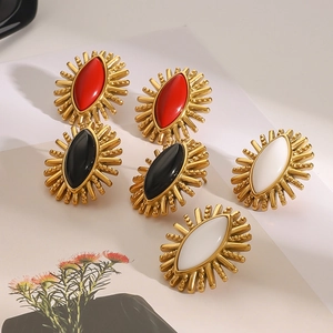 Detail of vintage gold stainless steel earrings with red black and white agate stones