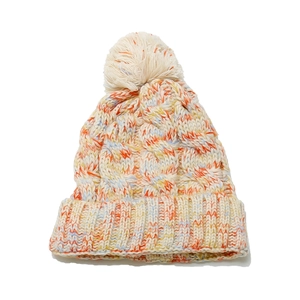 Close-up of thick cable knit texture and colorful mixed yarn on winter beanie hat