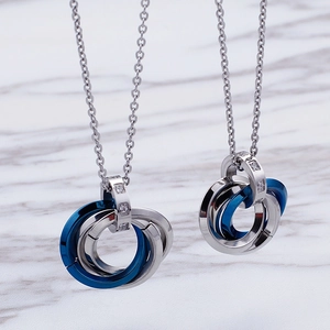 Interlocking tricolor rings pendant necklace with blue accents and sparkling crystals