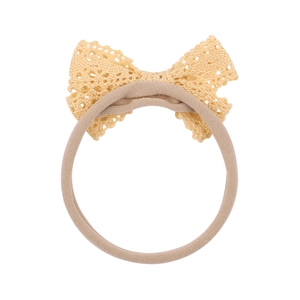 Sweet baby headband with a cream crochet lace bow on a soft stretchy nylon band
