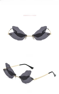 Detailed views of rimless dragonfly wing sunglasses with engraved black lenses and gold frame