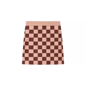Détail de la mini-jupe trapèze en maille à damier rose et marron, texture douce