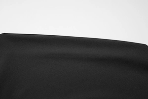 Close-up of the fine knit texture and black fabric material of the slim-fit t-shirt