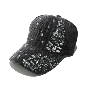 Detailed close-up of dark grey corduroy baseball cap featuring sparkling multi-shape rhinestones