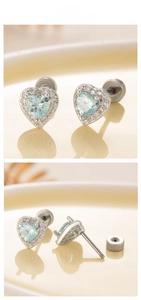 Detailed view of light blue heart zircon earrings with secure screw-back design and silver finish