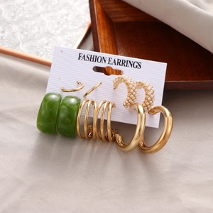 Detail view of 5-piece earring set with gold hoops, green resin and faux pearl accents