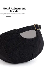 Close-up of black newsboy hat back with adjustable bronze metal buckle and fabric texture