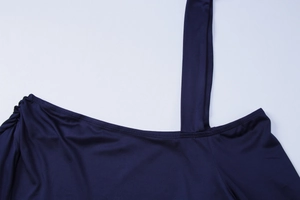 Détail de la robe satinée bleu marine montrant la bretelle et la texture lisse