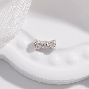 Macro shot of silver bow bead with pavé cubic zirconia for DIY jewelry making