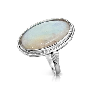Detail view of oval moonstone ring with leaf carvings and vintage silver finish