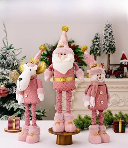 Pink Christmas plush toys with sequins including Santa, Reindeer and Snowman on a table