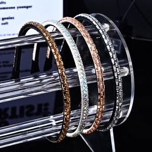 Set of four thin shimmering rhinestone headbands in gold, rose gold, and silver finishes