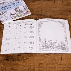 How to Draw Inky Wonderlands by Johanna Basford step-by-step coloring book on wood desk