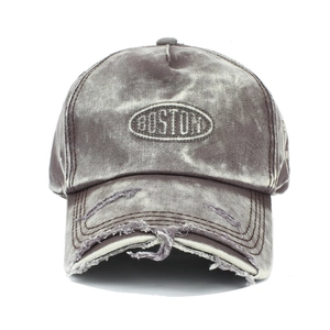Close-up of Boston letter embroidery and distressed ripped details on denim baseball cap