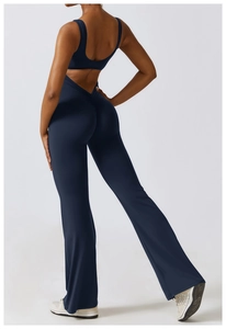 Detail of cross back cut-out and scrunch butt lifting seam on dark blue yoga jumpsuit