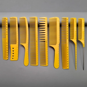 Set of yellow hair combs with scale markings and model numbers on a grey background