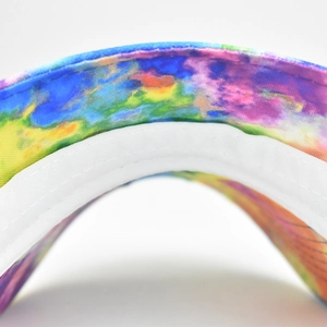 Macro view of colorful printed visor edge showing fine double stitching and white lining
