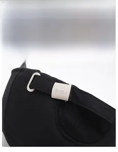 Macro detail of the adjustable metal buckle with SKEL logo on black winter sports cap