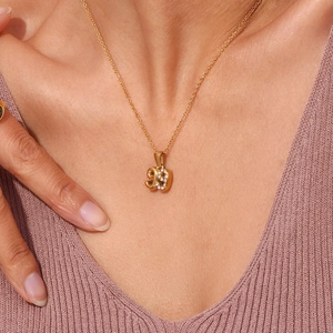Detail of 18K gold plated stainless steel year necklace with sparkling white rhinestones