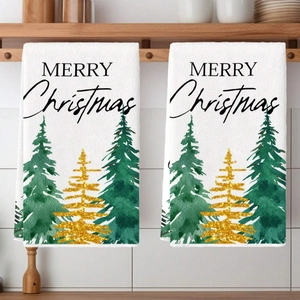 Detail of Christmas towels with Merry Christmas text and festive watercolor trees