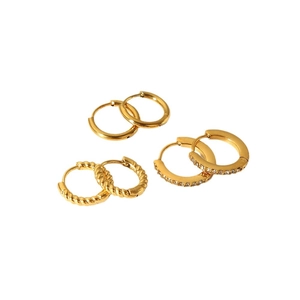 Three pairs of 18k gold plated stainless steel hoops in smooth, twisted, and zircon styles
