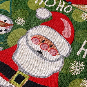Close-up of jacquard Christmas table mat with Santa Claus pattern and Ho Ho Ho text