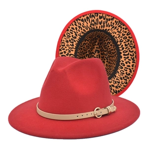 Detailed view of red fedora hat with leopard print brim lining and gold buckle trim