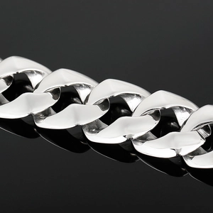 Macro view of polished silver stainless steel Cuban link chain with glossy metallic finish