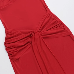 Detailed view of red dress featuring waist knot design and side ruching texture