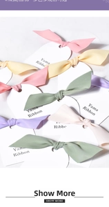 Macro detail of various pastel double-faced polyester ribbons on presentation cards