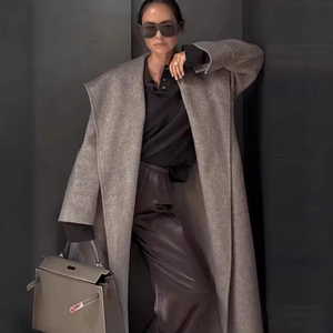 Elegant long grey wool coat for women with belted waist and sophisticated silhouette