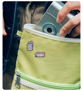 Detail of Mental Health Matters and Hello I Am enamel pins pinned on a green canvas bag