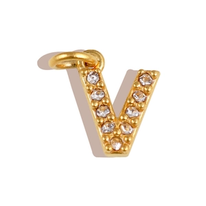 Detailed view of a gold-plated letter V pendant paved with sparkling zircons