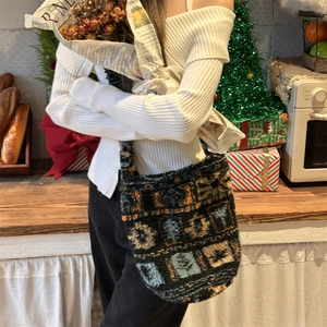 Detail of plush bucket bag with geometric patterns in a cozy winter holiday setting