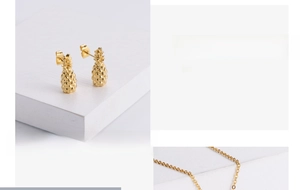 Detailed view of gold plated pineapple pendant necklace and matching stud earrings set