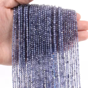 Detail view of 3mm faceted deep purple gemstone beads strands held by hand