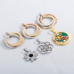 Collection of stainless steel tree and clover pendants with rhinestones and enamel finish